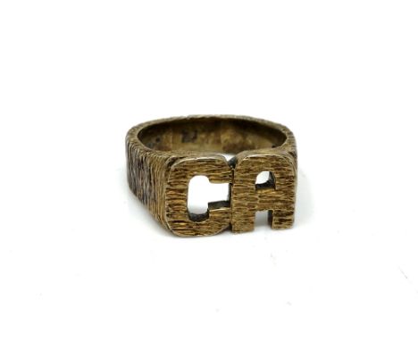 A 9ct gold ring with initials CA, size X.  CONDITION REPORT: 14.1g. 