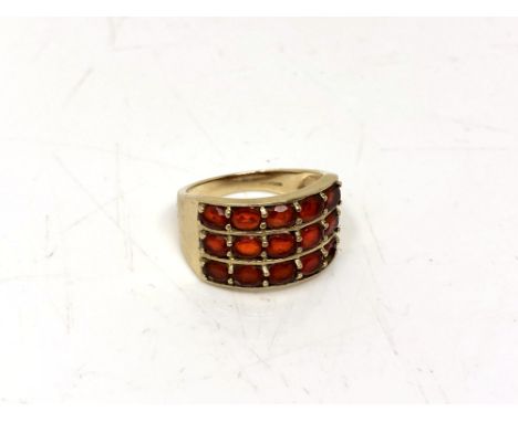 A 9ct gold dress ring set with red stones, size N CONDITION REPORT: 4.4g