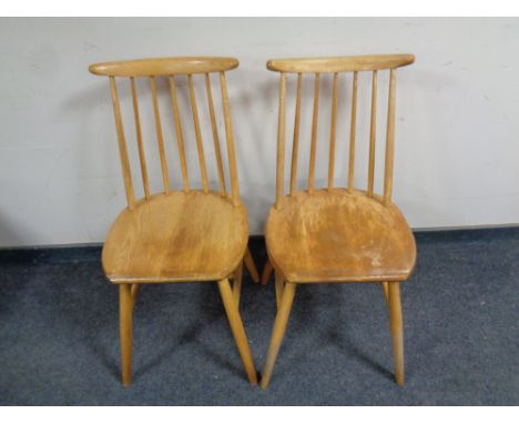 A pair of Ercol elm and beech spindle back dining chairs 