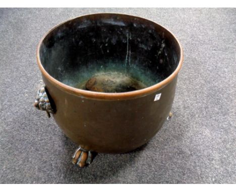 A 19th century copper lion mask planter on paw feet  