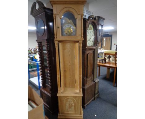 A continental stripped pine longcase clock with brass dial, pendulum and weights 