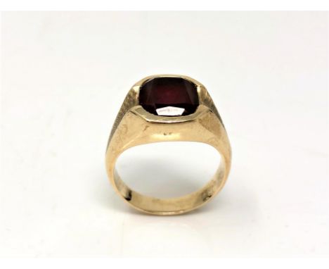 A garnet signet ring, stamped both '9' and '10k', size U.  CONDITION REPORT: 9.5g. 