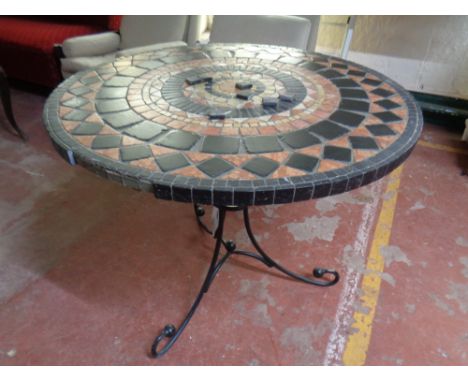 A tile topped mosaic patio table on metal pedestal  