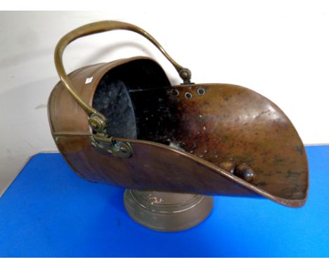 A 19th century copper brass handled coal helmet with shovel 