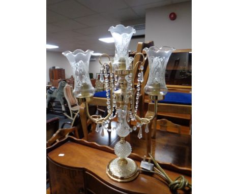 A decorative brass and glass four way table lamp with glass fluted shades 