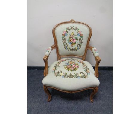 A continental carved beech salon armchair upholstered in a tapestry fabric  