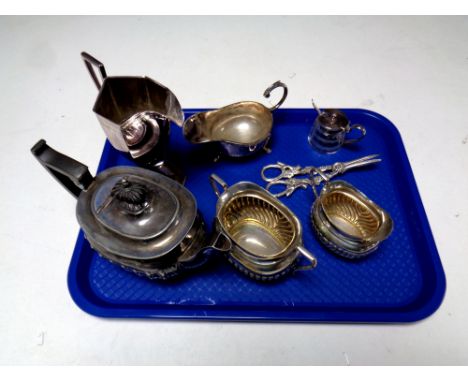 A tray containing antique plated wares to include three piece tea service, pair of grape scissors, jug, sauce boat and cruet 