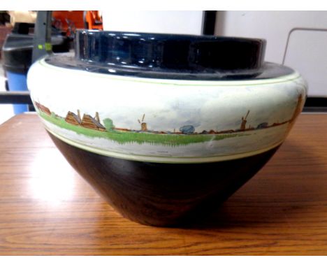 A glazed pottery planter depicting Dutch windmill scenes  