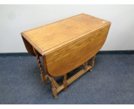 A 20th century oak barley twist gate leg table 