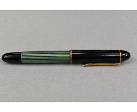 A Pelikan 140 piston fill fountain pen in green striated pattern and black cap having Pelikan 14ct nib. Approx 12.4cm