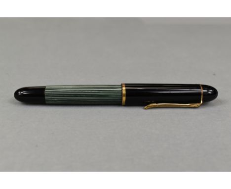 A Pelikan 140 piston fill fountain pen in green striated pattern and black cap having Pelikan 14ct nib. Approx 12.4cm