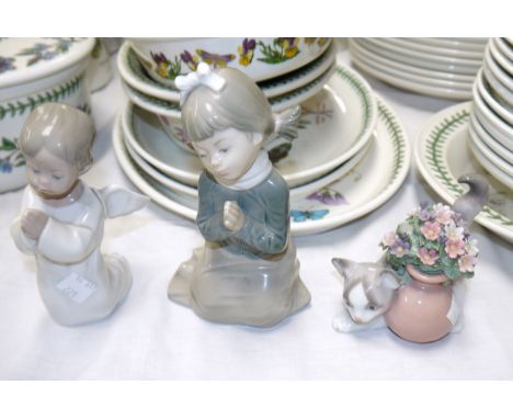 A Lladro angel praying, a Lladro cat with flowers and a praying Nao girl