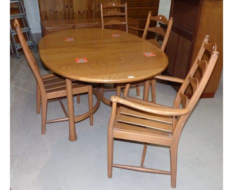 A modern Ercol light elm dining suite comprising oval extending dining table with four chairs (2&2) 