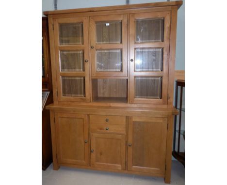 A modern light oak display sideboard with 3 bevelled glass doors above and single drawer and 3 cupboards below