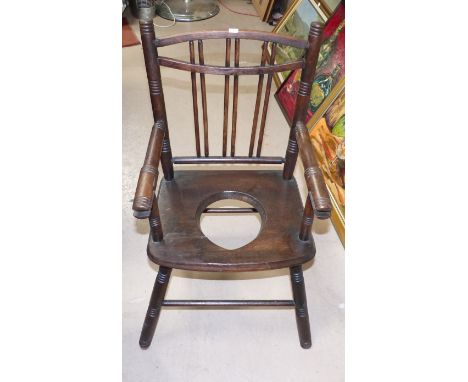 An Edwardian child's turned wood commode chair
