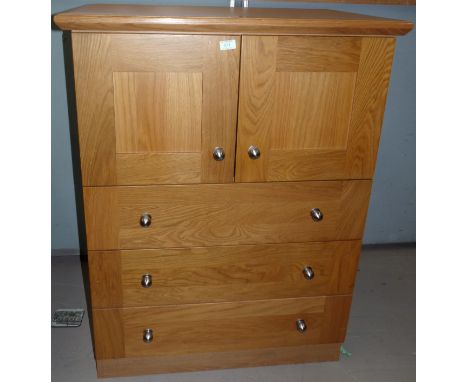 A modern light oak tallboy of 3 drawers and double cupboard, by Neville Johnson; a matching display cabinet and similar bookc