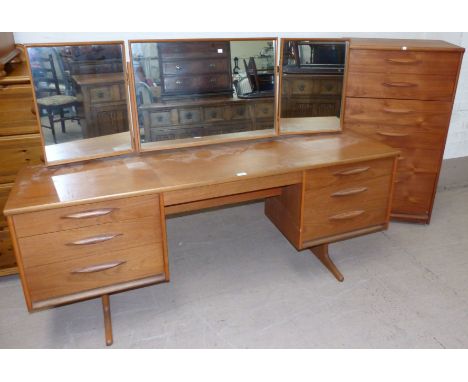 A 1960's two piece teak bedroom suite comprising kneehole dressing table and stool, a six height chest of drawers; two simila