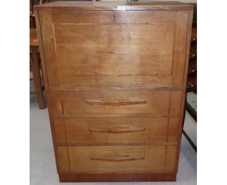 A 1950's light oak secrétaire by Arthur W Simpson with fall front fitted removeable interior and three drawers.