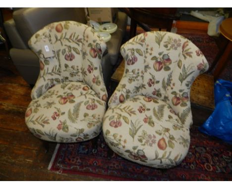 A pair of mid 19th century French walnut framed low seated chairs, having tapestry woven foliate upholstery, raised on cabrio