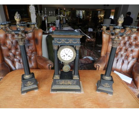 A mid 19th century French ormolu and patinated bronze portico clock garniture, the clock set with a Roman and Arabic enamelle