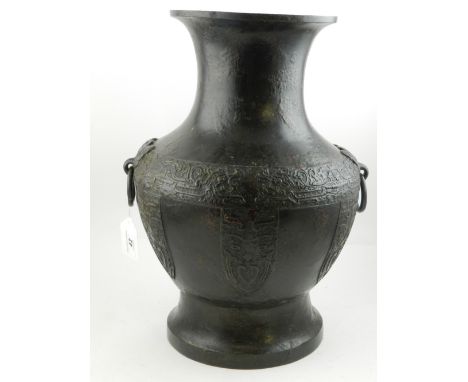 A Chinese cast bronze baluster vase, having stylised palmette shaped reserves, with relief geometrical design.  H.42cm