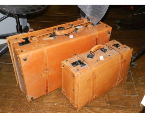 Two brown leather suitcases, detailed with black metal to handle and lock. together with a Winsor & Newton fine art painting 