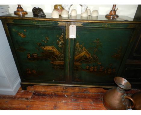 An early 20th century green lacquered side cabinet, Chinoiserie decorated with stylised figures amongst landscapes, the field