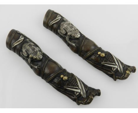 A pair of Chinese bronze brush rests in the form of a bamboo stick, having applied toad and spider and applied scorpion to th