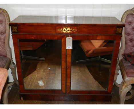 A fine Regency rosewood side cabinet, cut brass inlaid with anthemions and scrolls, fitted a pair of mirrored cupboard doors 