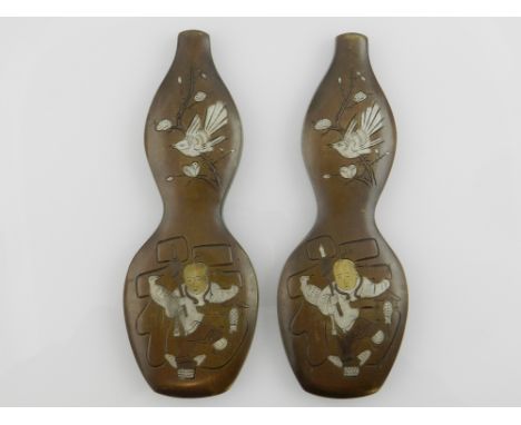 A pair of Chinese bronze paperweights in the form of double gourd vases, depicting a child at play. H.15cm 