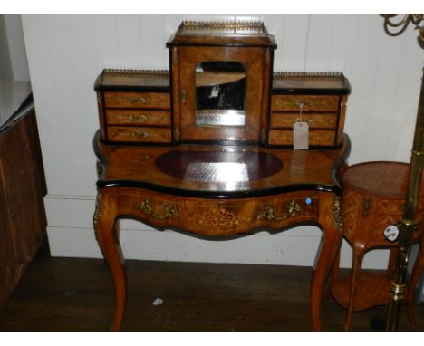 A mid 19th century French figured and burr walnut bonheur de jour, gilt metal mounted and parcel ebonised, the upper superstr