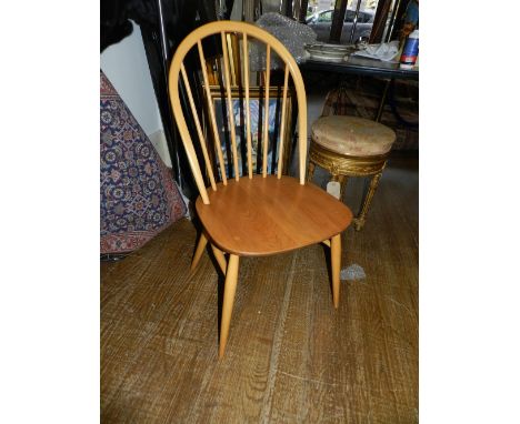 A set of Ercol comb back dining chairs, with elm seats.