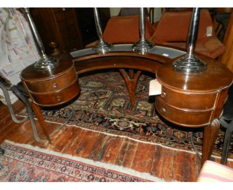 An Art Deco style oak concave dressing table, fitted four drawers on moulded legs.  H.71cm W.134cm