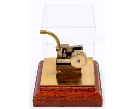 A miniature horizontal stationary steam engine, raised on wooden plinth with perspex display case, height of case 8cm