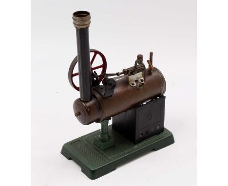 A Bing and later stationary spirit fired overtype steam engine comprising of tin housed horizontal boiler with safety whistle