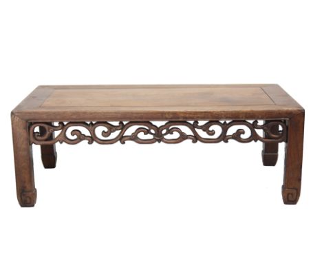 A Chinese hardwood Kang table, circa 1900, with a foliate carved frieze, on square section legs with scroll carved feet, heig