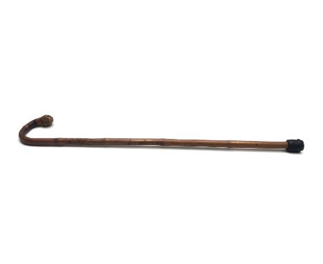 A Japanese bamboo walking stick, with root knop and carved with figures to the shaft, signed, height 81.5cm.