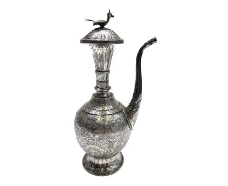 A Chinese silver ewer, early 20th century, with a bird finial, the body with dragons, height 29cm.  Condition report: dent at