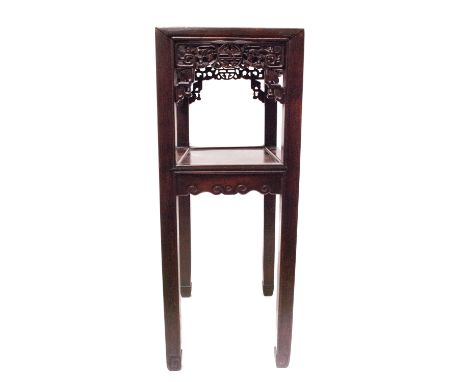 A Chinese hardwood jardiniere stand, 19th century, the foliate pierced frieze above a rectangular undertier on square section