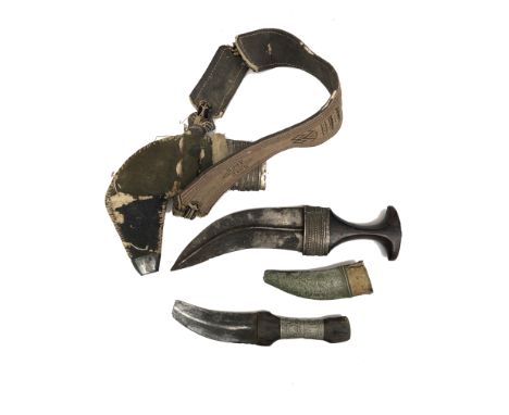 An Eastern Kukri, in part white metal scabbard, length 34cm and another smaller, length 26cm.  