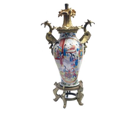 A Chinese baluster porcelain lamp, circa 1900, painted in a Canton palette, with two panels depicting figures in interiors an