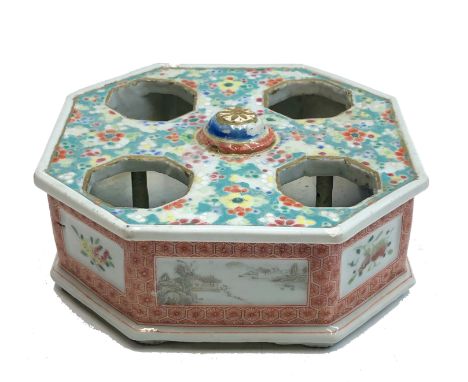 A Chinese porcelain millefleur octagonal cruet stand, 18th/19th century, the side with panels of river landscapes and fruit, 