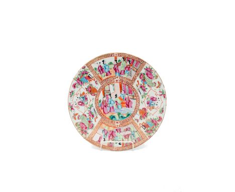 A Chinese Canton porcelain charger, 19th century, the central circular panel with figures in an interior scene, the border se