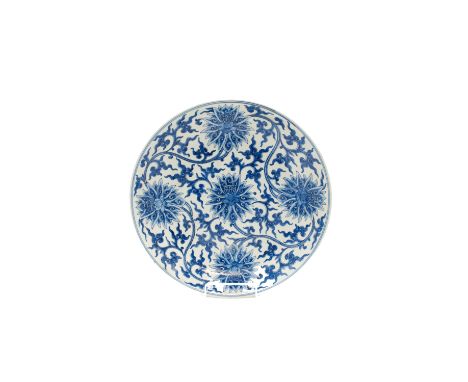 A large Chinese Ming style blue and white porcelain dish, 20th century, decorated with flowerheads and tendrils, blue seal ma