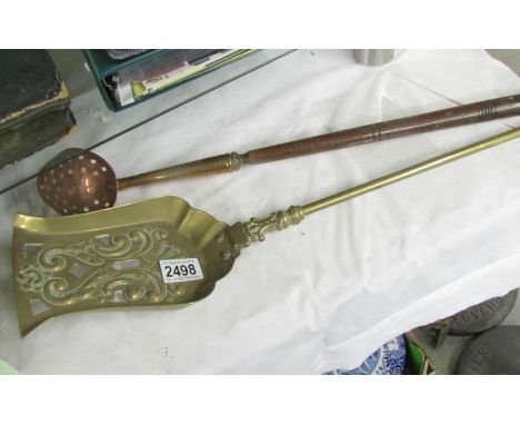 A brass shovel and a copper straining ladle.