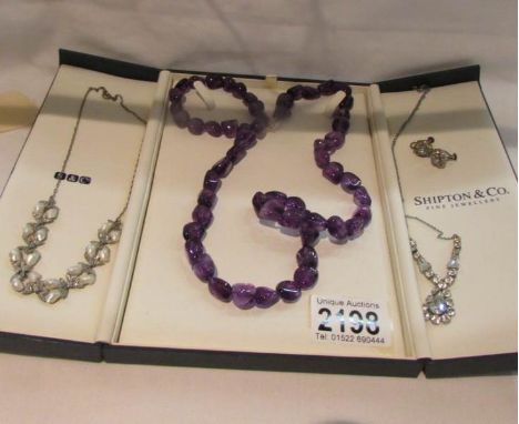 A cased 'Shipton &amp; Co.,' amethyst necklace with silver clasp, a pair of silver earrings, an necklace and an unusual half 
