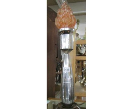 A chrome plated mortar bomb table lamp with flame glass shade.