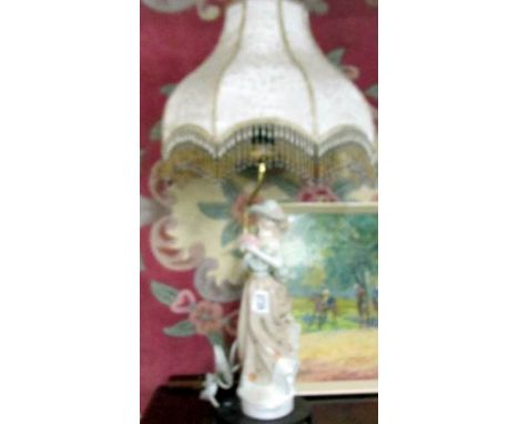 A figural table lamp with shade.