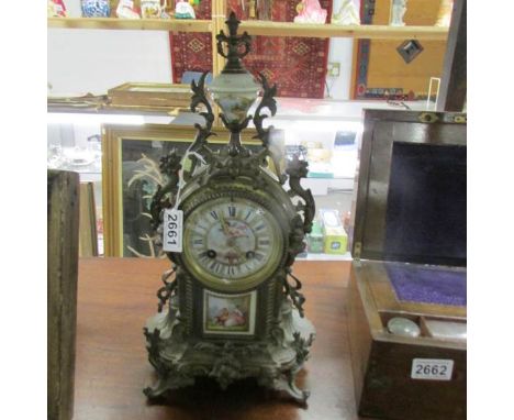 A French mantle clock with enamel dial and porcelain panel.