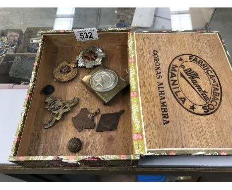 An old cigar box containing badges, medals, buckles &amp; button etc.